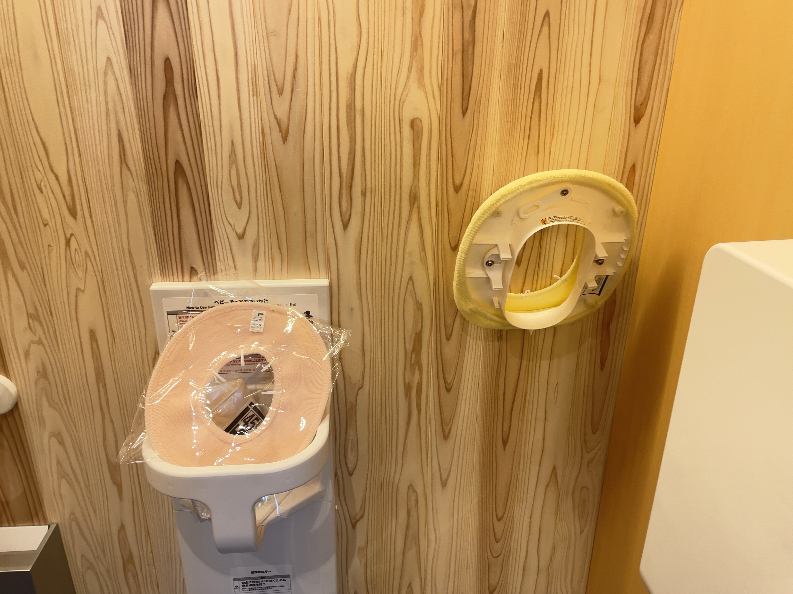 Large restroom stall with baby chair (1 for both men and women)